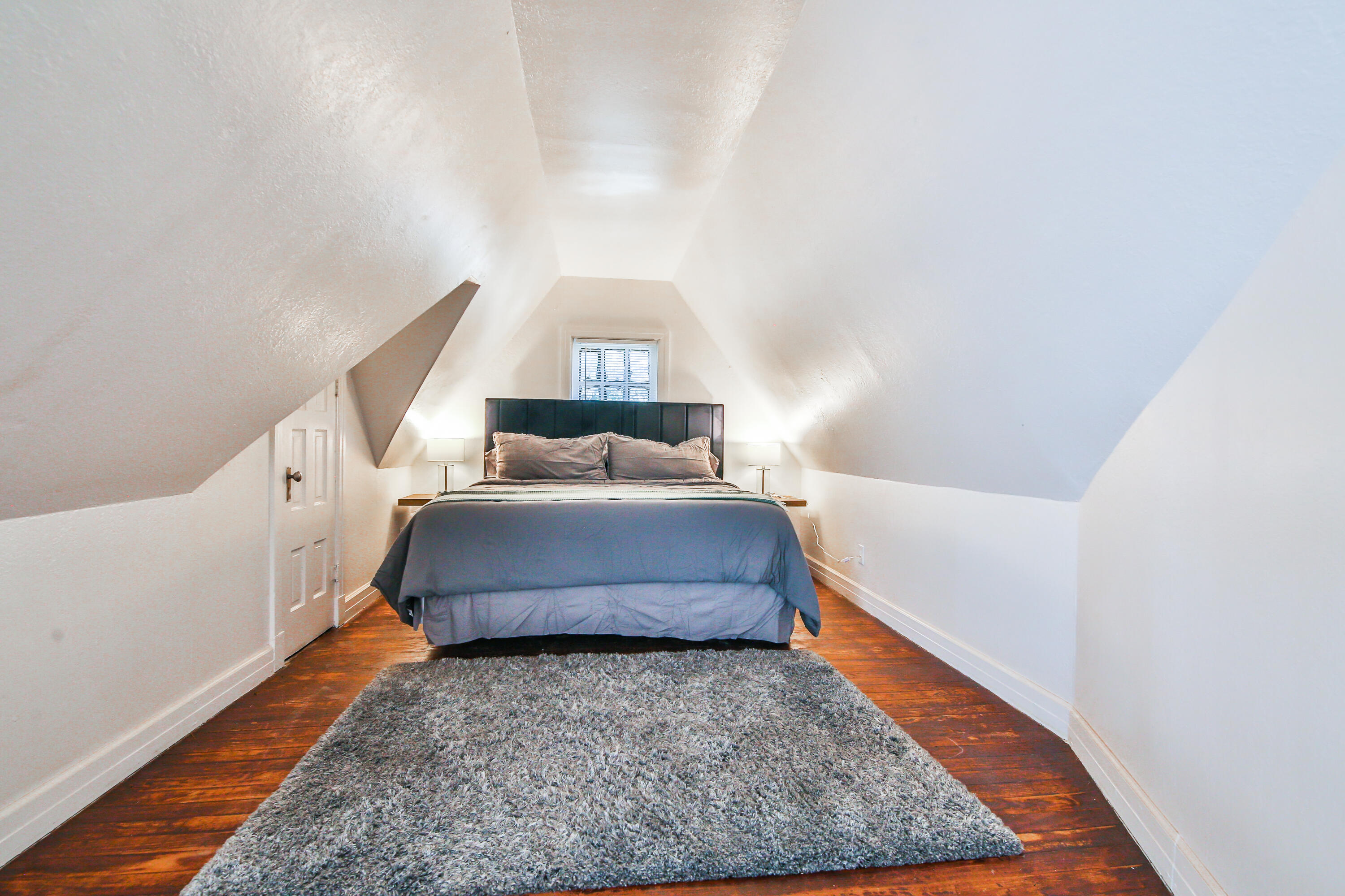 2309 17th Street Lubbock, TX 79401 - Photo 19 of 26 a bedroom with a bed and a night stand