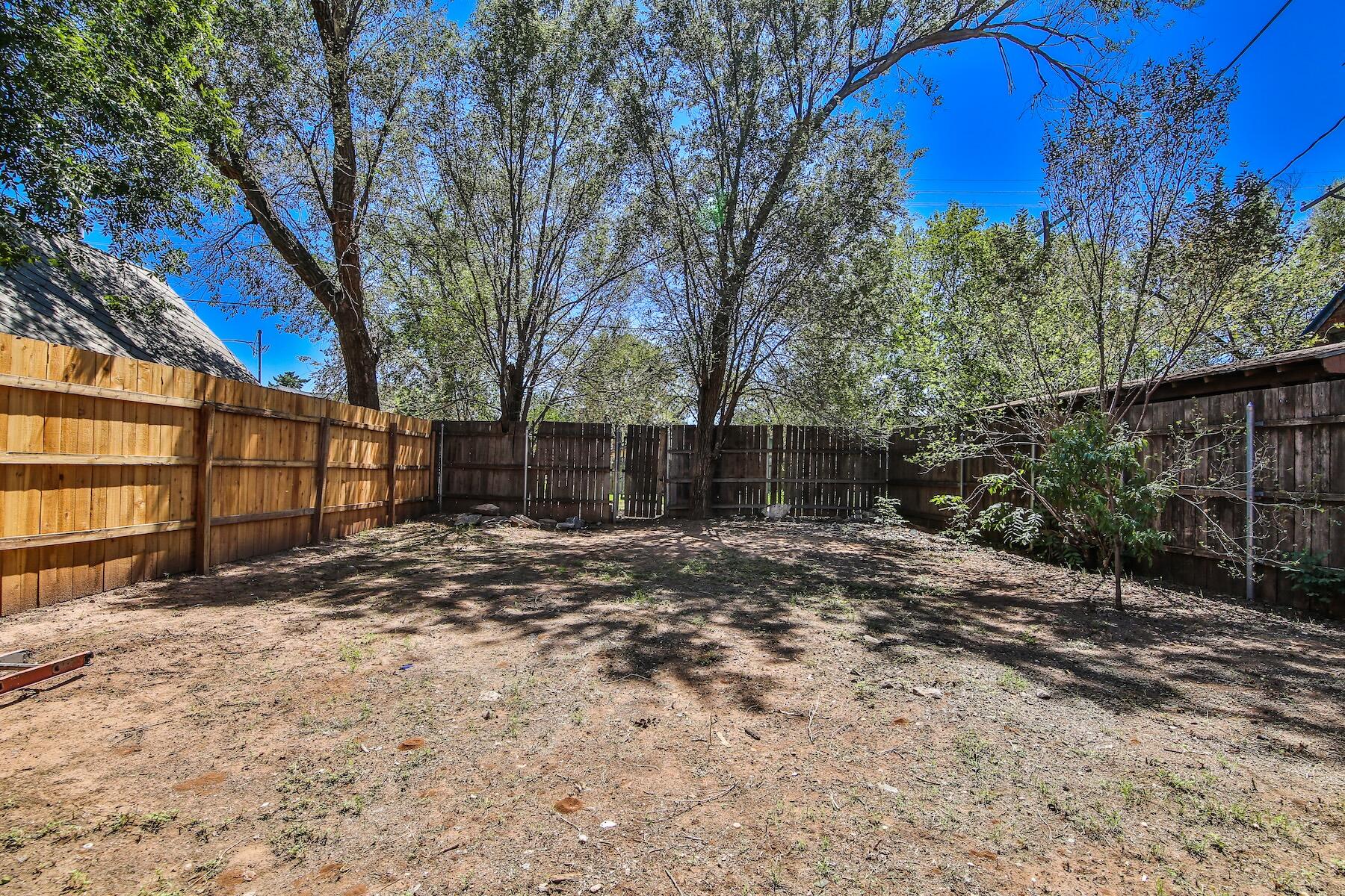 2309 17th Street Lubbock, TX 79401 - Photo 22 of 26 a view of a backyard with large trees