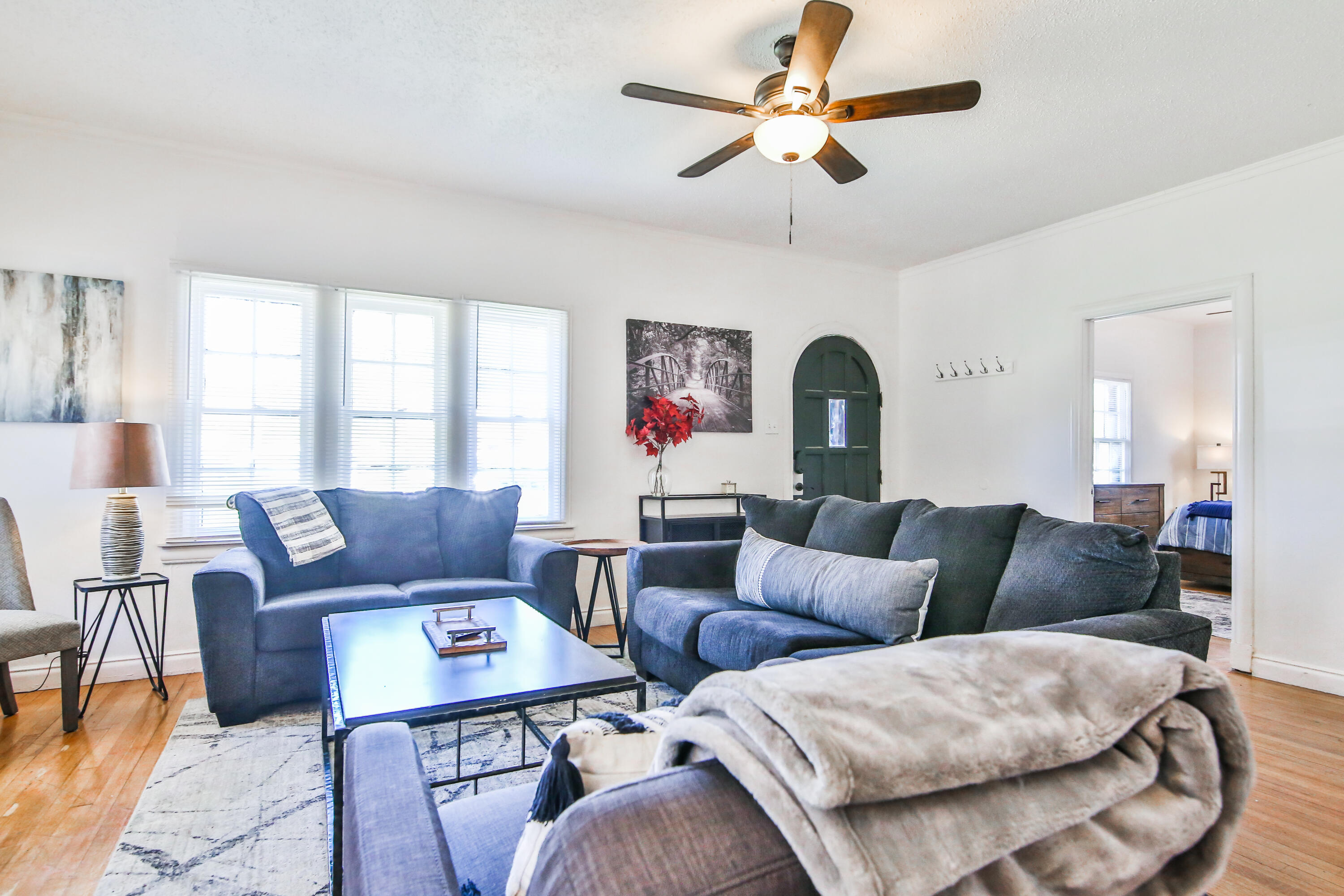 2309 17th Street Lubbock, TX 79401 - Photo 3 of 26 a living room with furniture a chandelier and a window