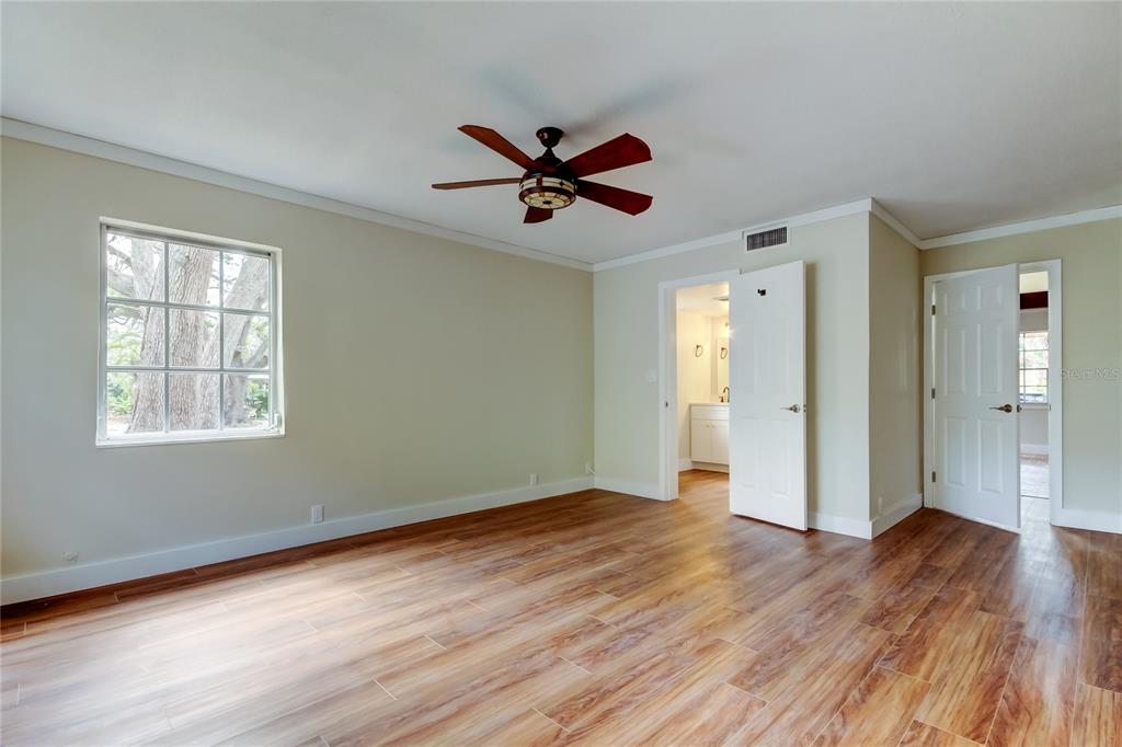 2901 Pelham Road North St. Petersburg, FL 33710 - Photo 17 of 32 a view of an empty room with window and wooden floor