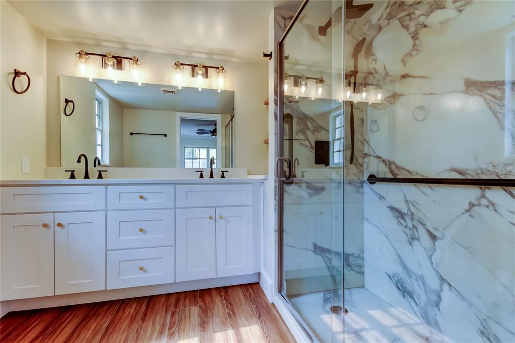 2901 Pelham Road North St. Petersburg, FL 33710 - Photo 19 of 32 a spacious bathroom with double vanity and a mirror