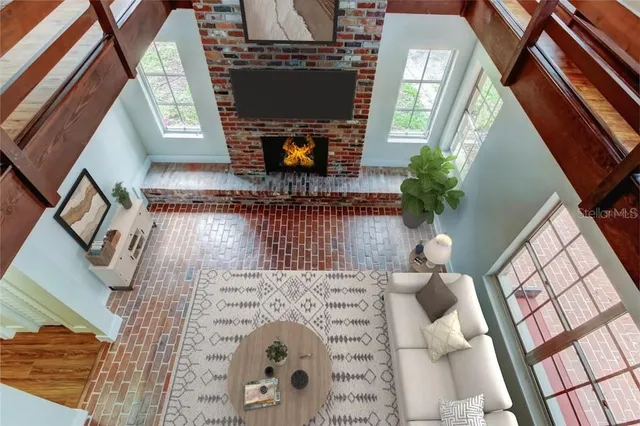 a living room with furniture a fireplace and a flat screen tv