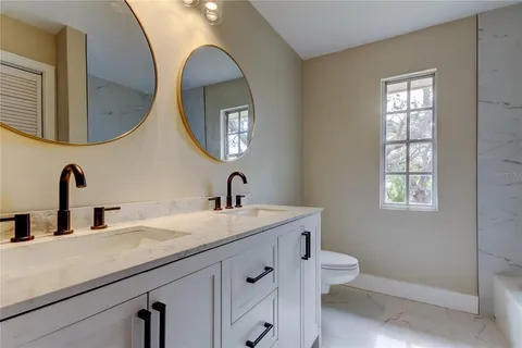 a bathroom with a double vanity sink and a mirror