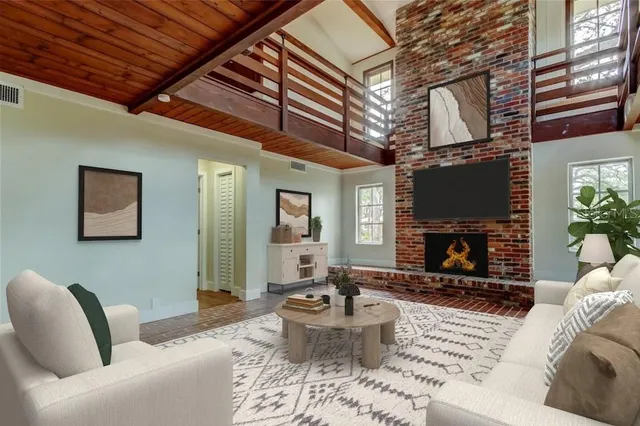 a living room with furniture a fireplace and a table