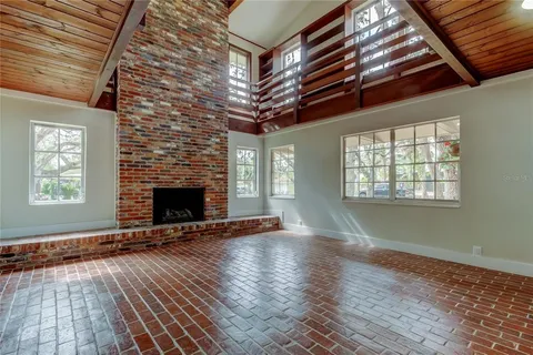 a view of an empty room with exposed radiator and fireplace