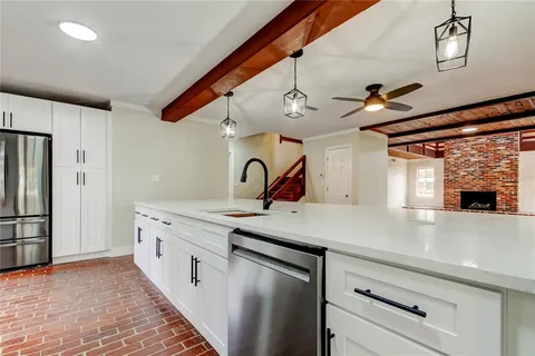 a kitchen with stainless steel appliances a sink and a refrigerator