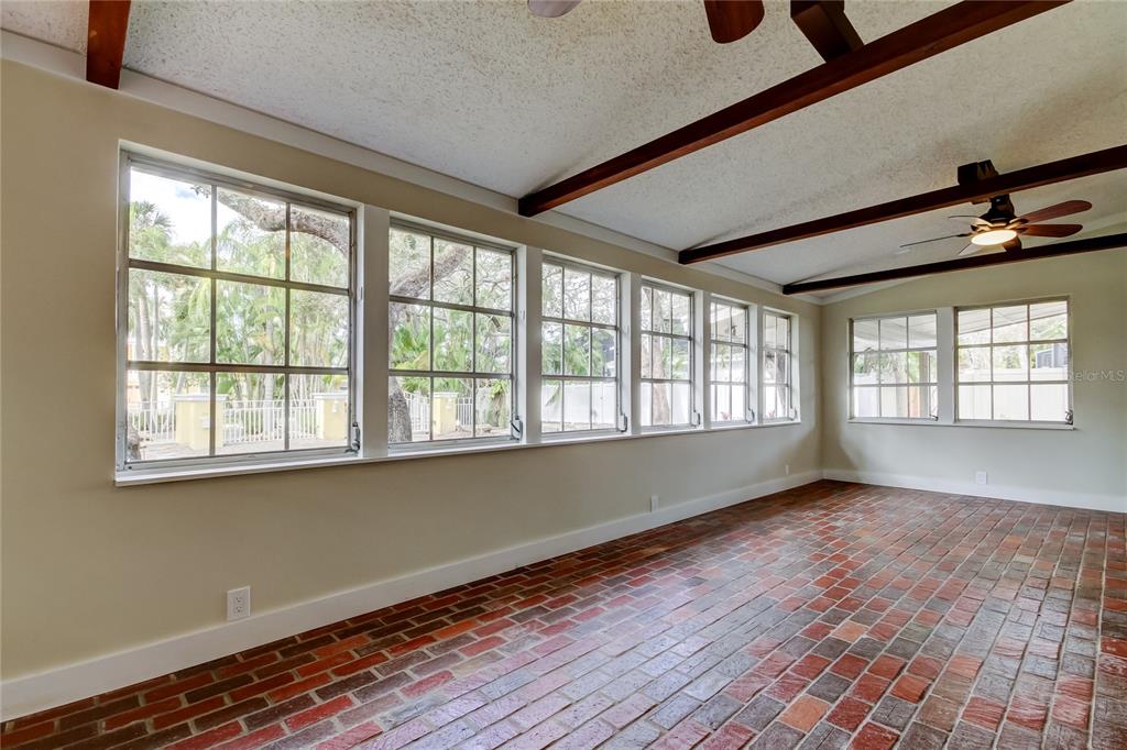 2901 Pelham Road North St. Petersburg, FL 33710 - Photo 9 of 32 a view of an empty room with wooden floor and a window