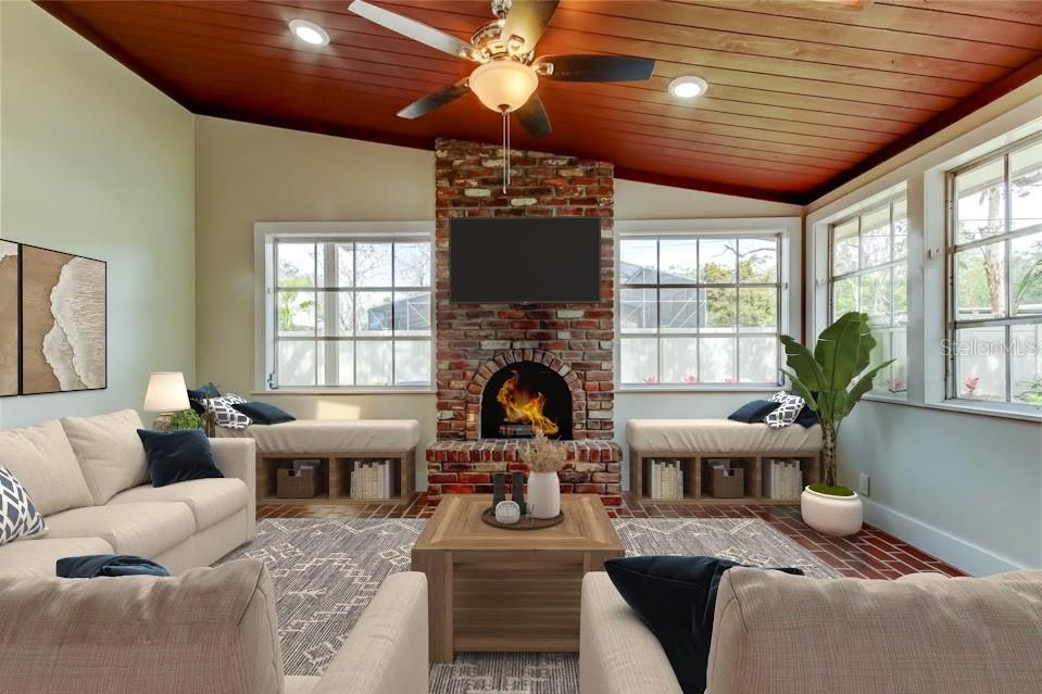 2901 Pelham Road North St. Petersburg, FL 33710 - Photo 10 of 32 a living room with furniture a fireplace and a chandelier