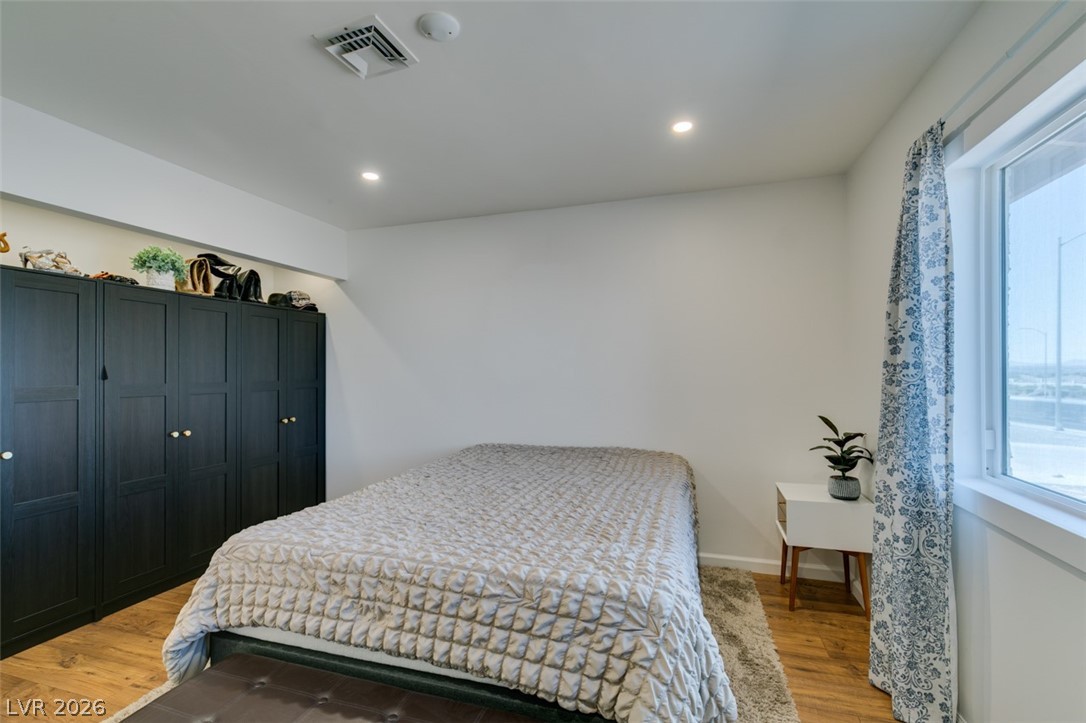 892 North Hollywood Boulevard Las Vegas, NV 89110 - Photo 43 of 81 This cozy bedroom features recessed lighting and durable hardwood flooring for comfort and style.