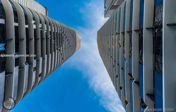 a view of staircase with lots of frames on wall and wooden floor