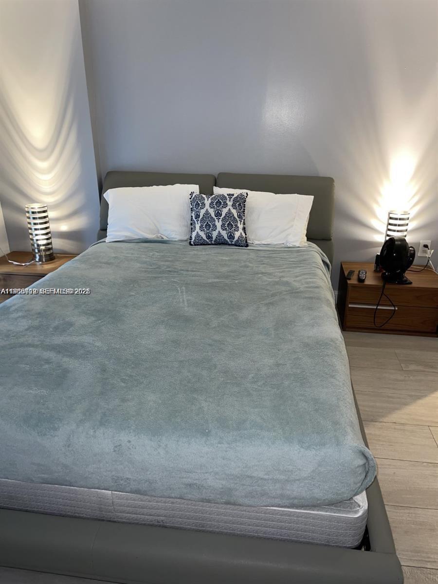 55 Southwest 9th Street, Unit 2307 Miami, FL 33130 - Photo 11 of 35 a bedroom with a bed and window