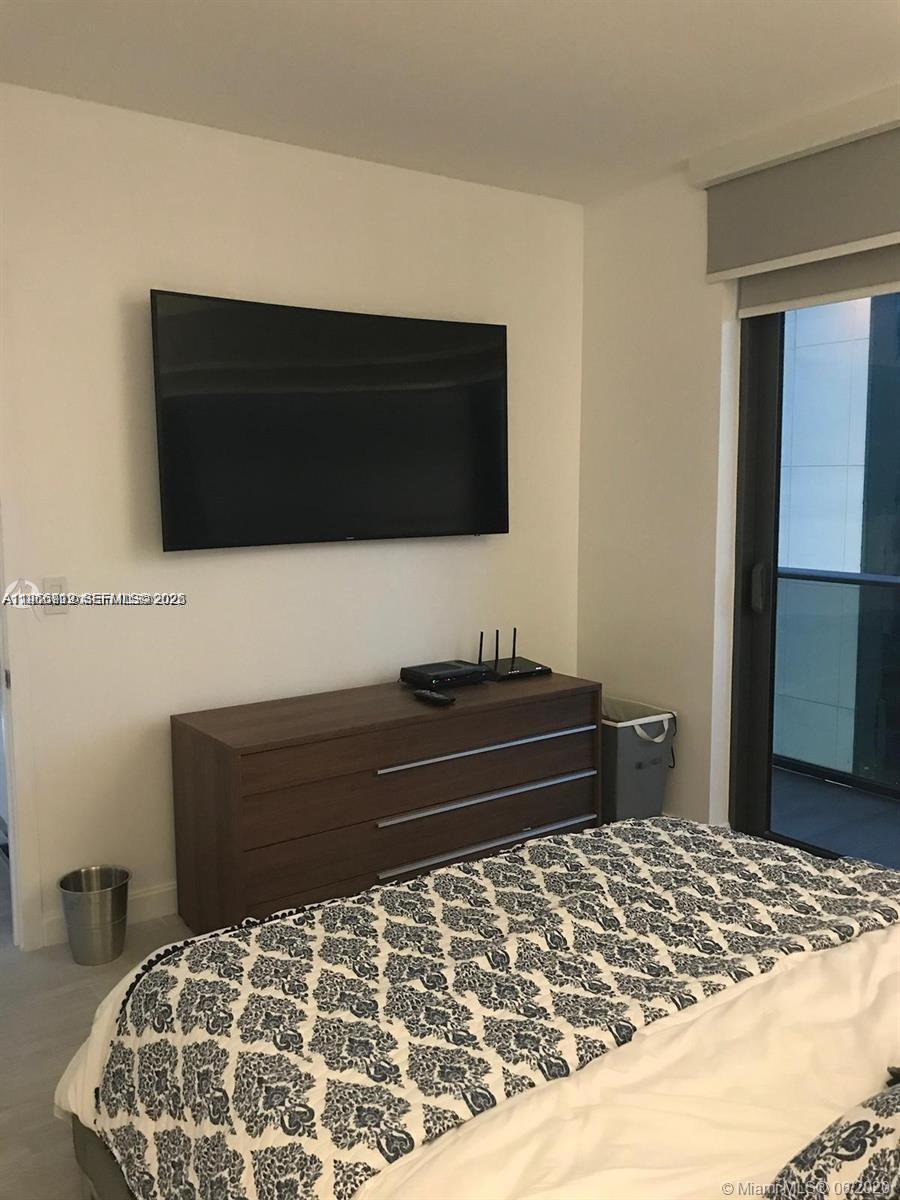 55 Southwest 9th Street, Unit 2307 Miami, FL 33130 - Photo 13 of 35 a bedroom with a bed and a television