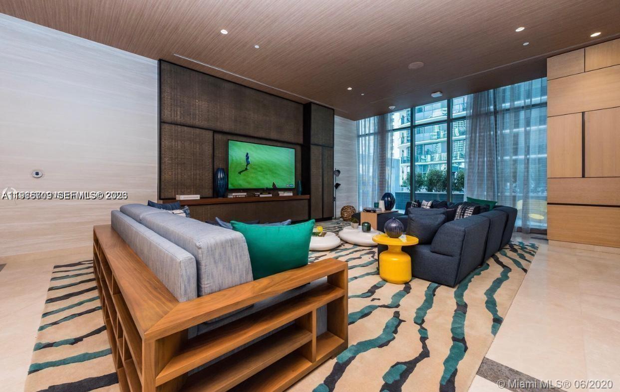 55 Southwest 9th Street, Unit 2307 Miami, FL 33130 - Photo 26 of 35 a living room with furniture and a flat screen tv