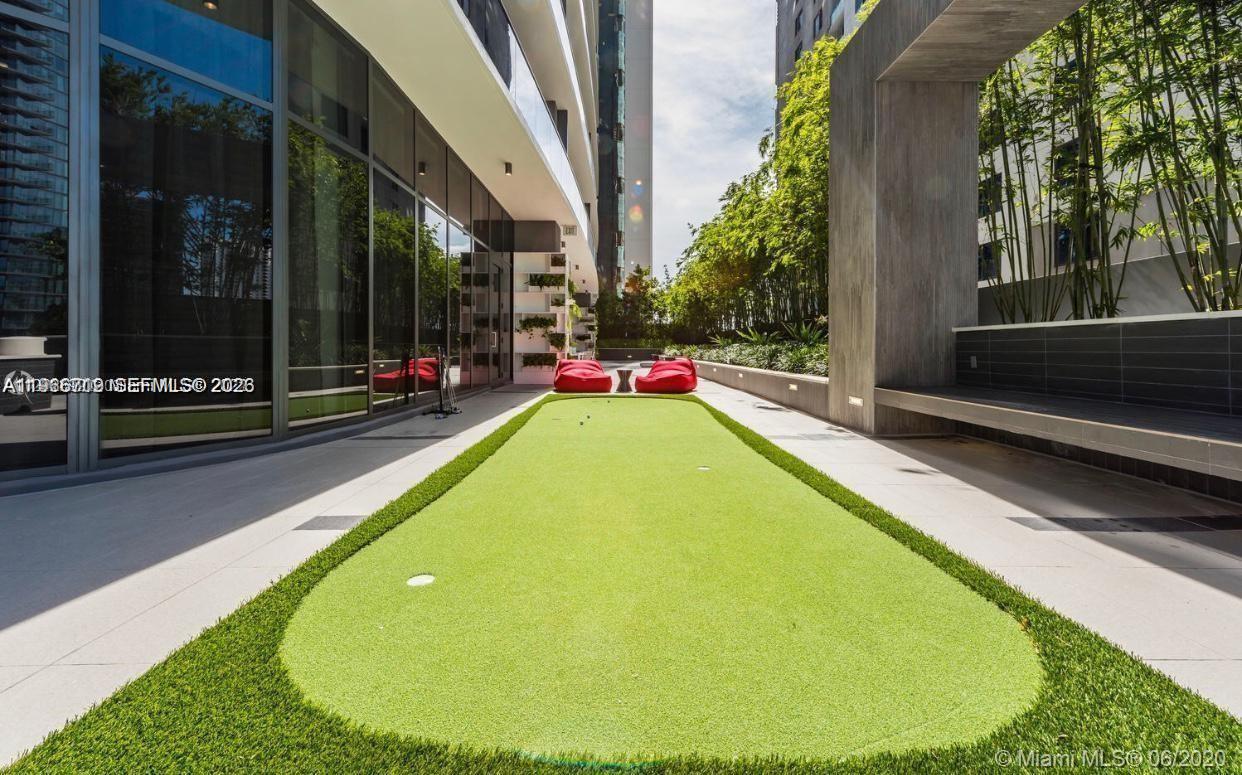 55 Southwest 9th Street, Unit 2307 Miami, FL 33130 - Photo 29 of 35 a view of swimming pool with outdoor seating and yard