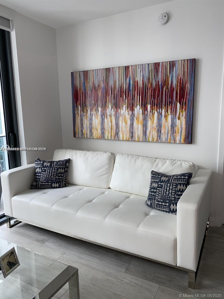 55 Southwest 9th Street, Unit 2307 Miami, FL 33130 - Photo 9 of 35 a living room with a couch
