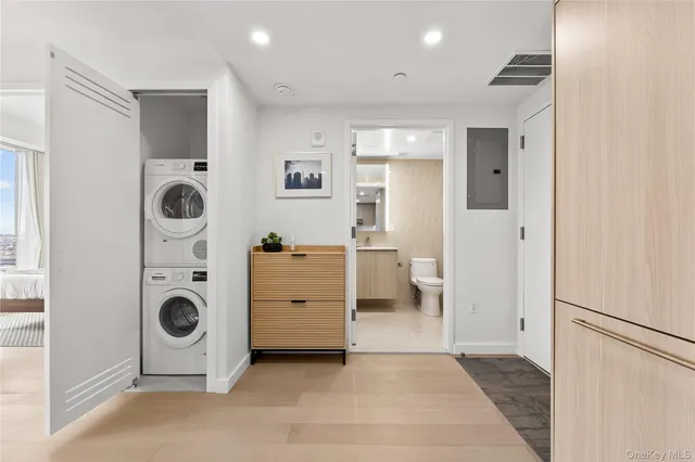 a view of a kitchen with a refrigerator a washer and dryer