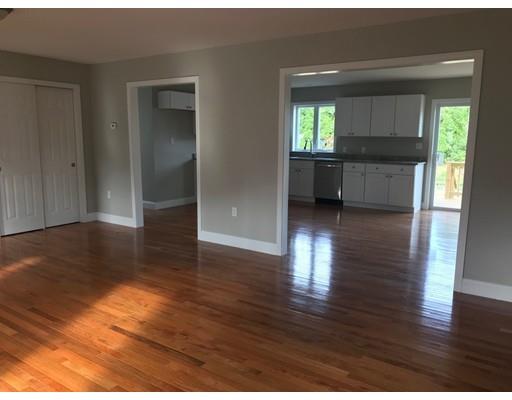 74 York Street Fall River, MA 02721 - Photo 7 of 19 a view of a hallway with wooden floor and a kitchen