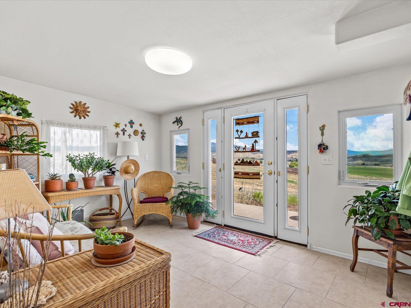 68149 Sunshine Road Montrose, CO 81401 - Photo 12 of 33 a living room with furniture and a potted plant