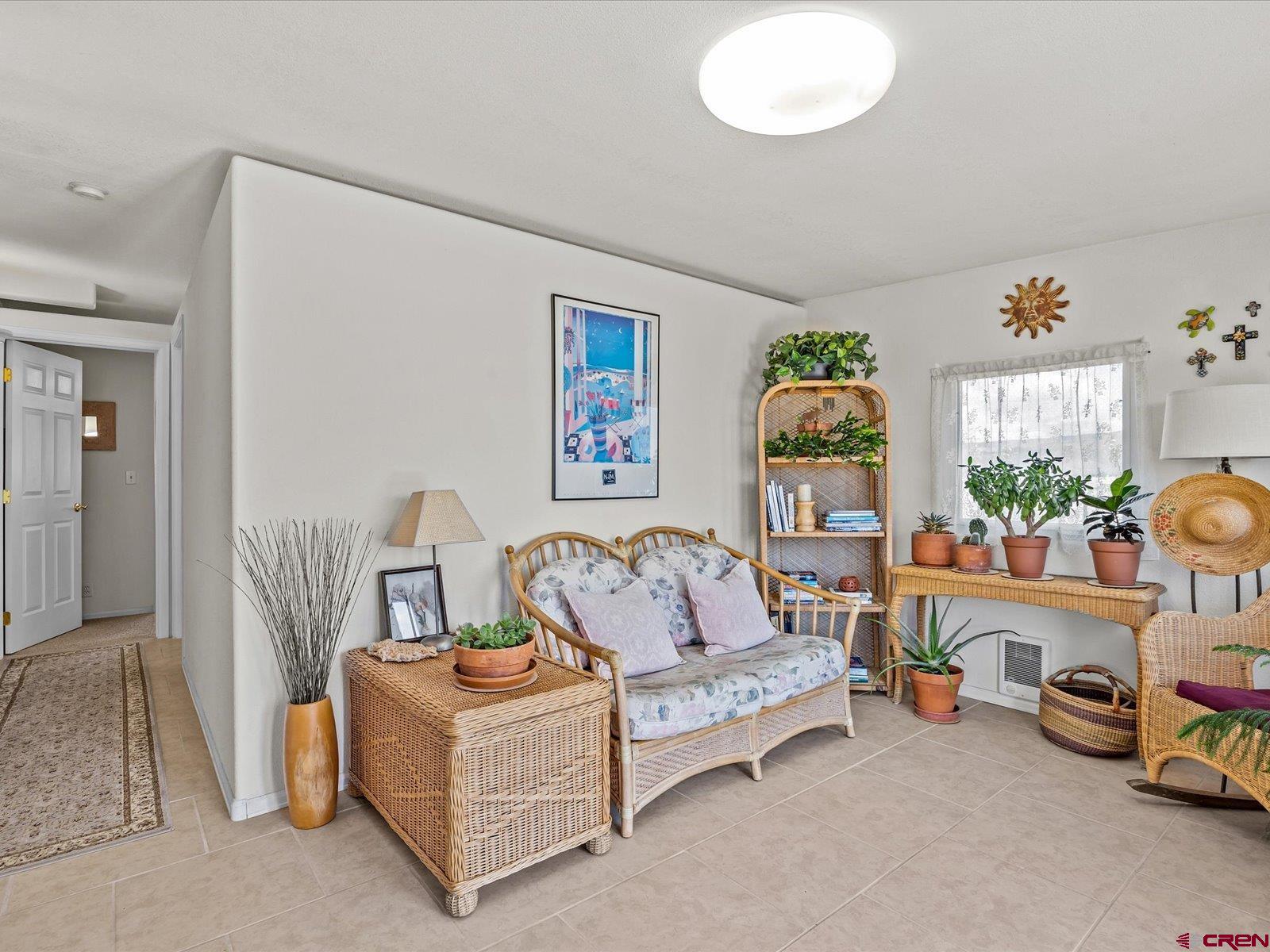 68149 Sunshine Road Montrose, CO 81401 - Photo 13 of 33 a living room with furniture and a potted plant on a dresser