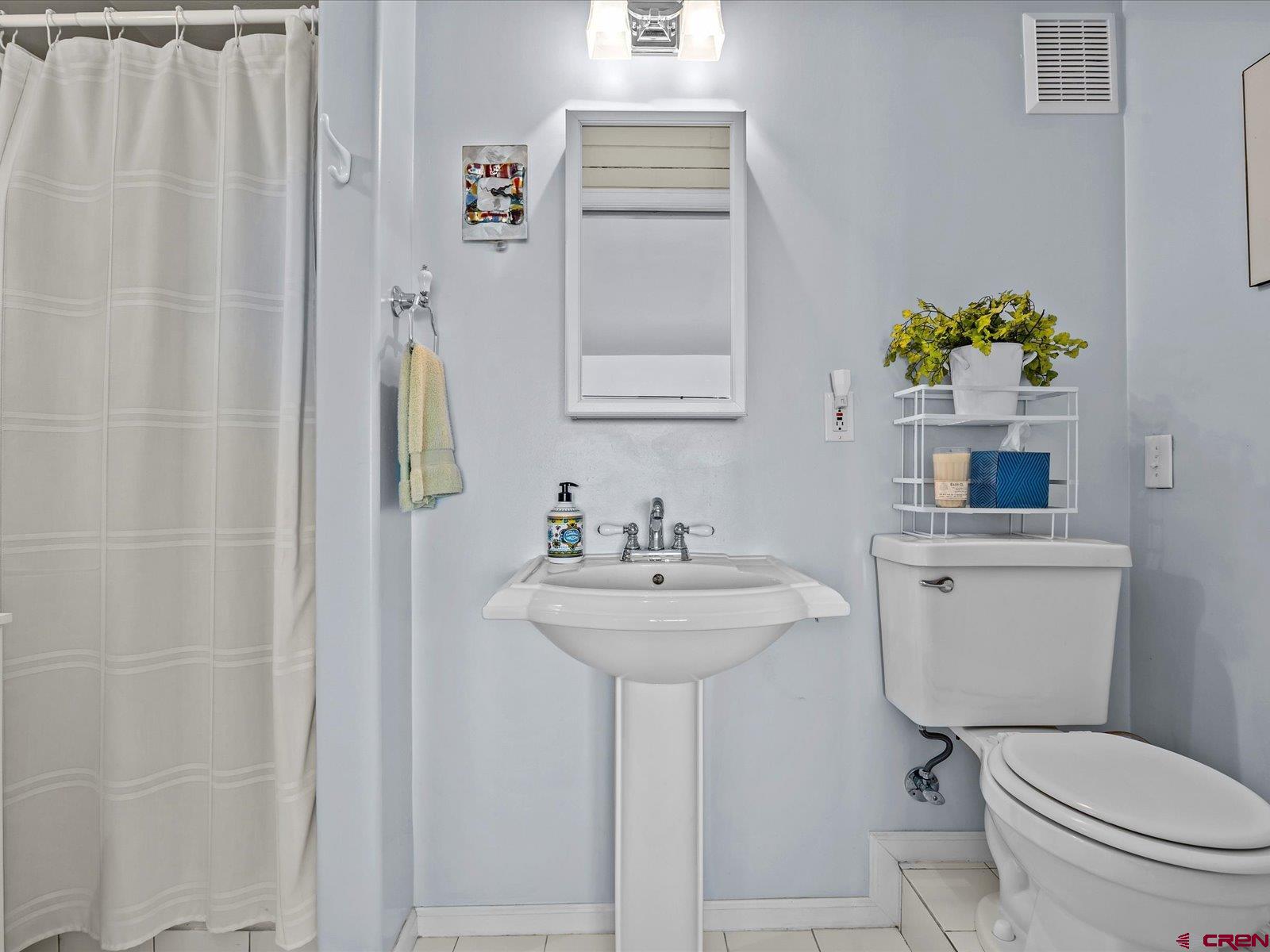 68149 Sunshine Road Montrose, CO 81401 - Photo 16 of 33 a bathroom with a sink a toilet and a mirror