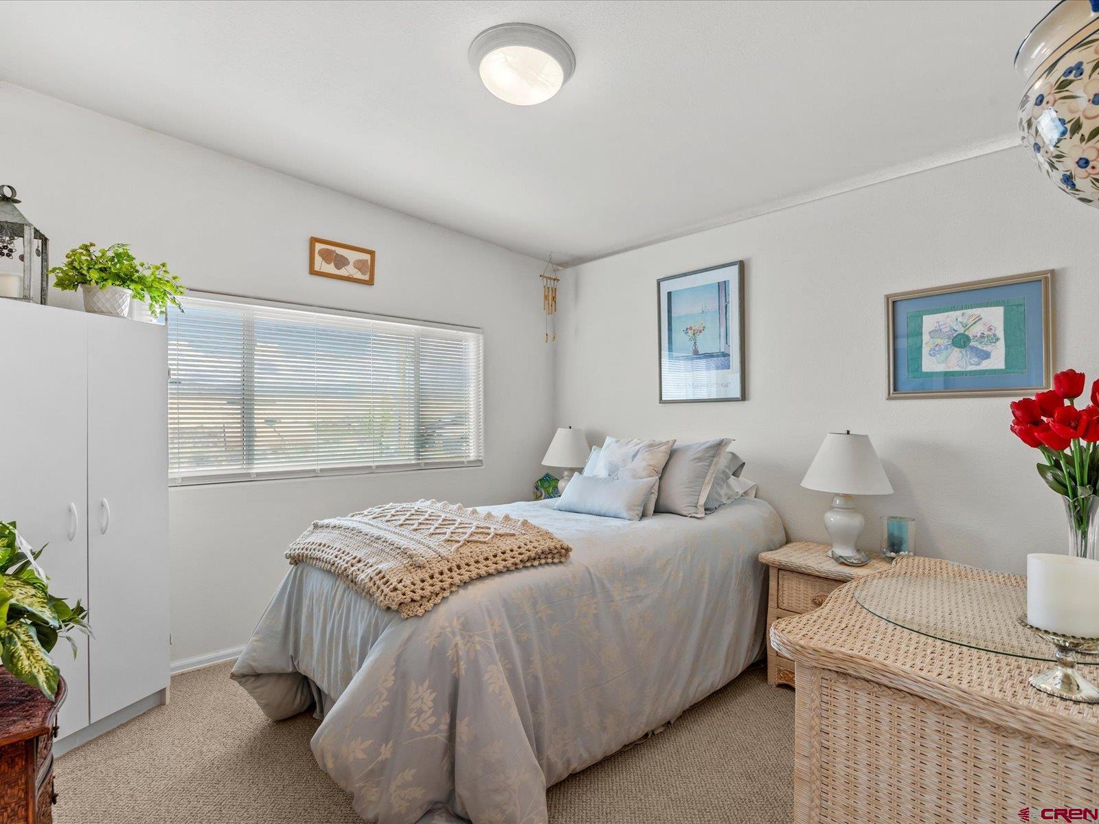 68149 Sunshine Road Montrose, CO 81401 - Photo 17 of 33 a bedroom with a bed and a painting on the wall