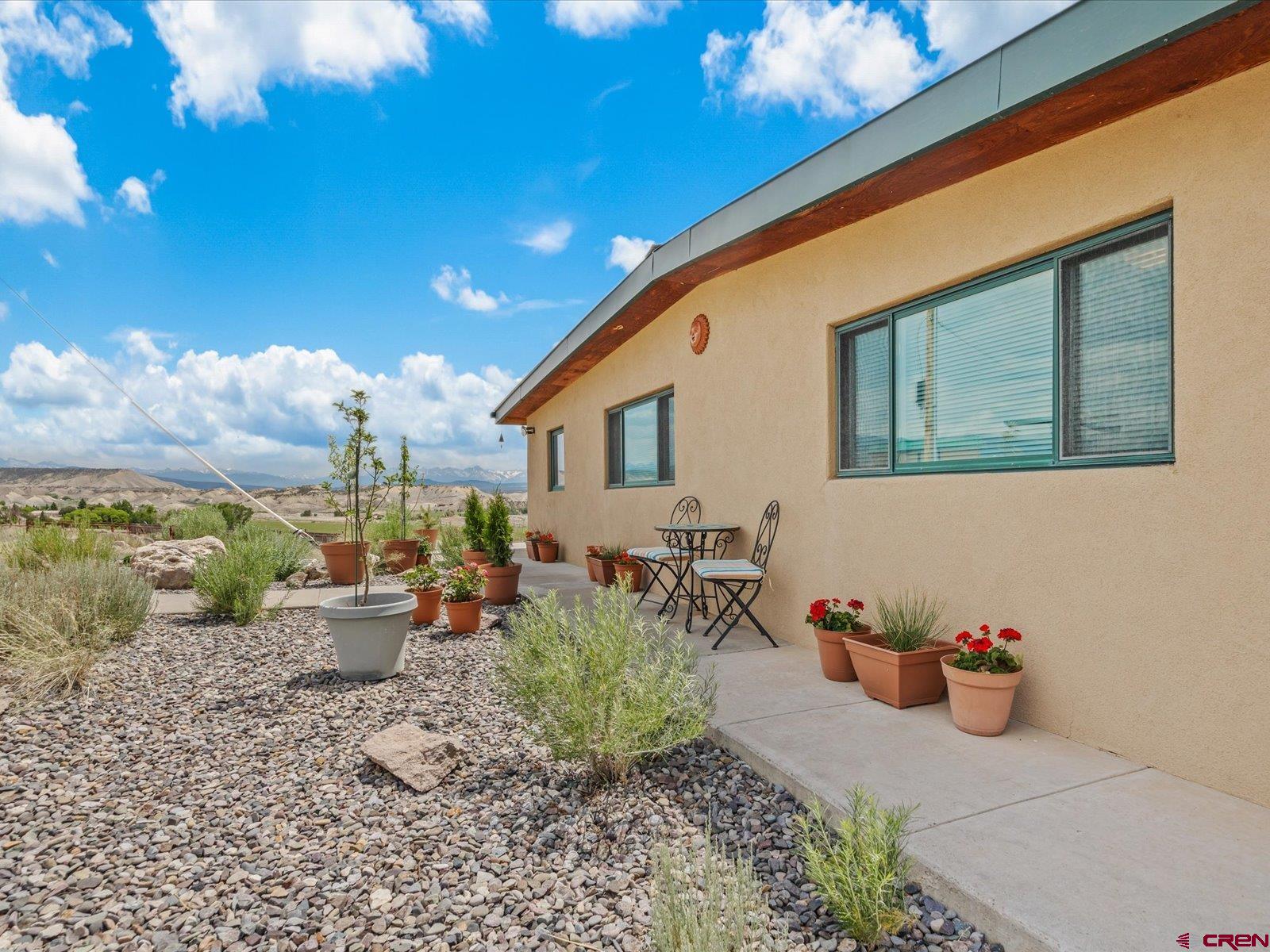 68149 Sunshine Road Montrose, CO 81401 - Photo 23 of 33 a view of a patio with chairs and potted plants