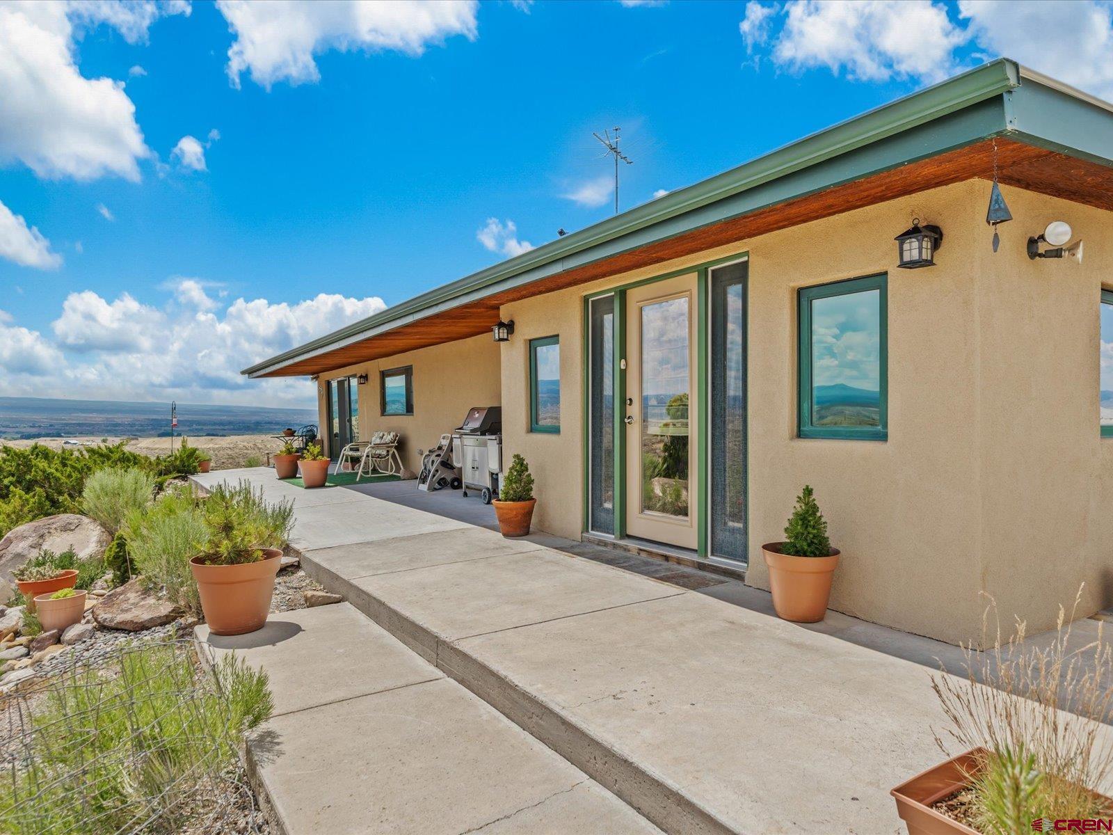 68149 Sunshine Road Montrose, CO 81401 - Photo 3 of 33 a front view of a house with sitting area