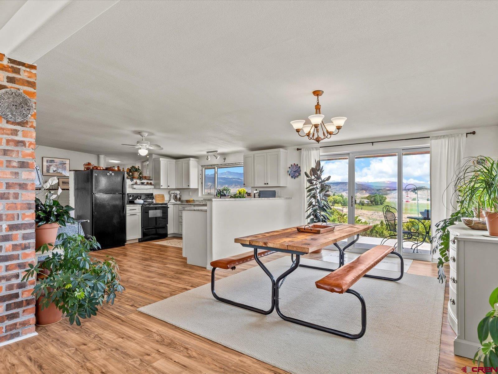 68149 Sunshine Road Montrose, CO 81401 - Photo 4 of 33 a living room with patio furniture and a chandelier
