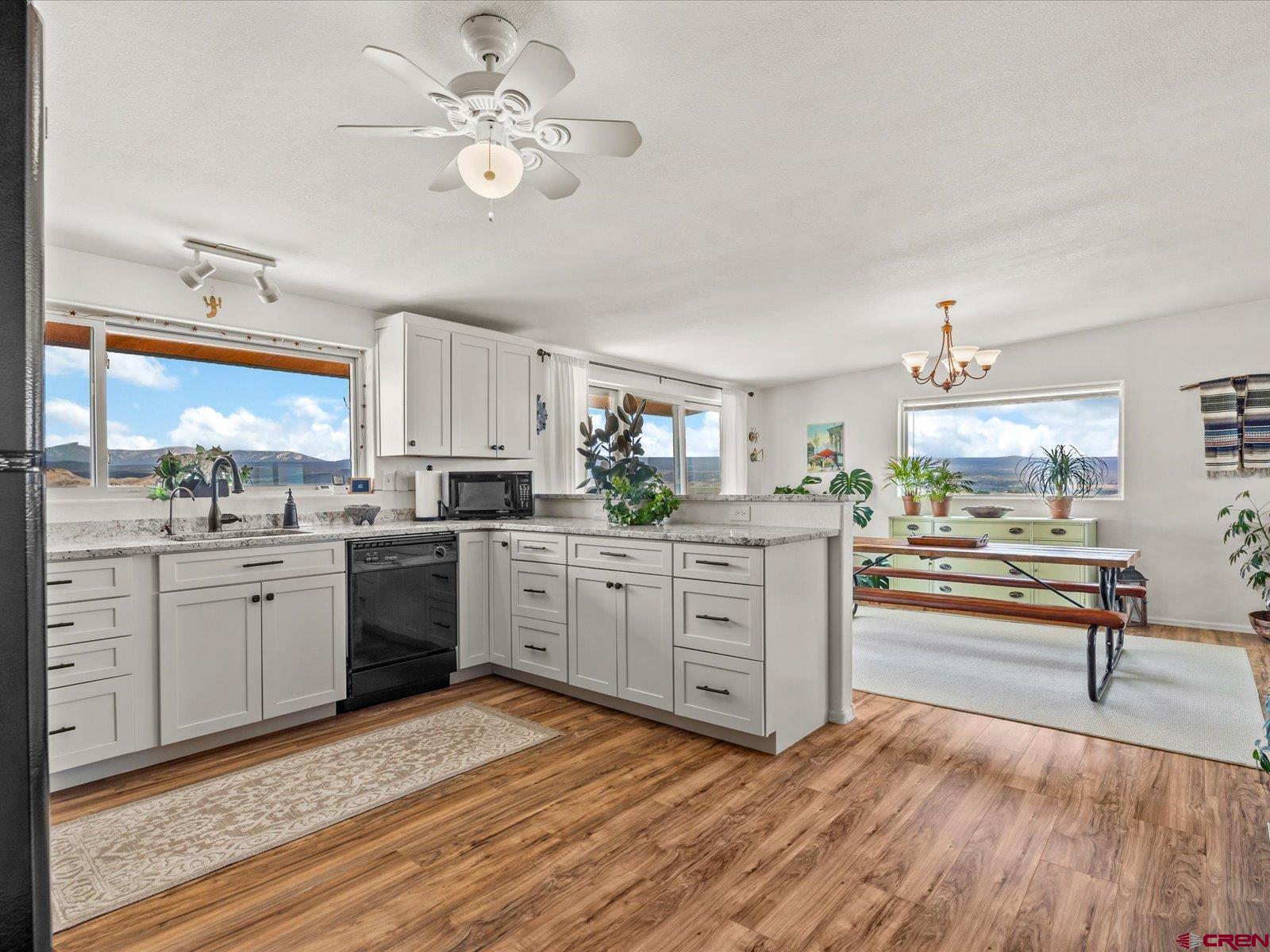 68149 Sunshine Road Montrose, CO 81401 - Photo 7 of 33 a kitchen with cabinets stainless steel appliances and a large window