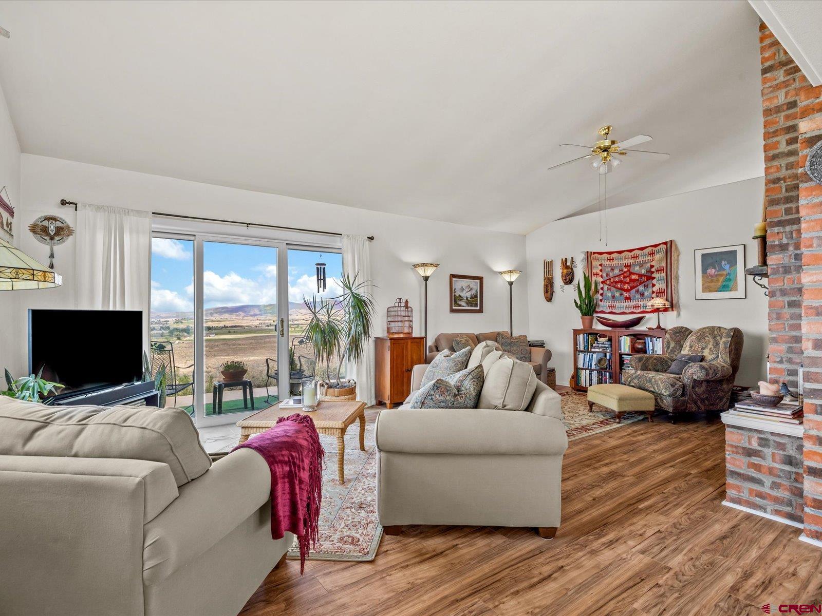 68149 Sunshine Road Montrose, CO 81401 - Photo 8 of 33 a living room with furniture and a flat screen tv