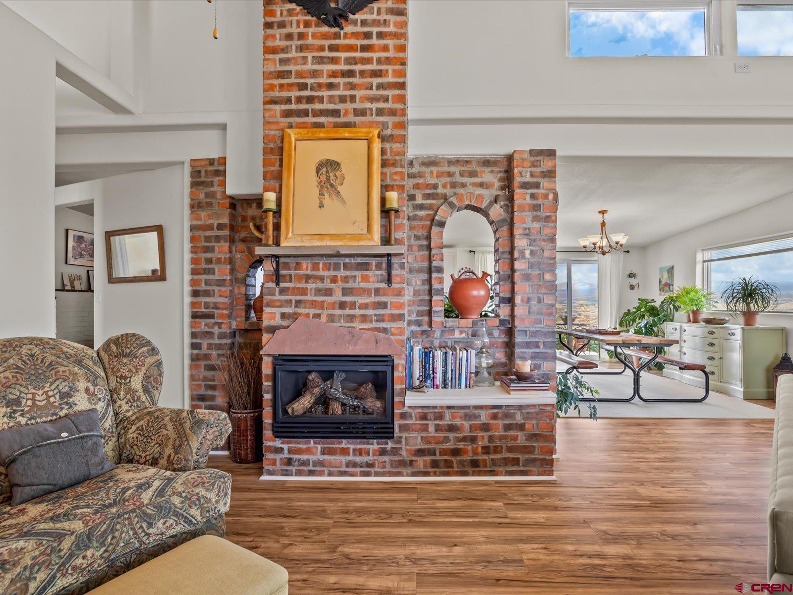 68149 Sunshine Road Montrose, CO 81401 - Photo 9 of 33 a living room with furniture and a fireplace