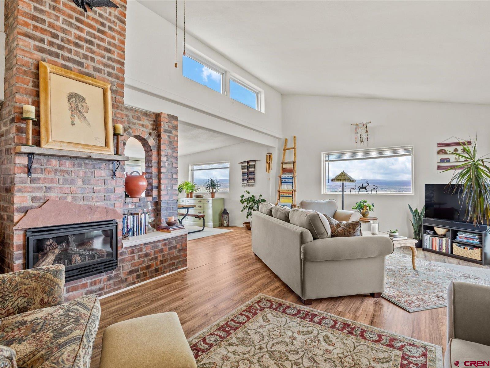 68149 Sunshine Road Montrose, CO 81401 - Photo 10 of 33 a living room with furniture a flat screen tv and a fireplace