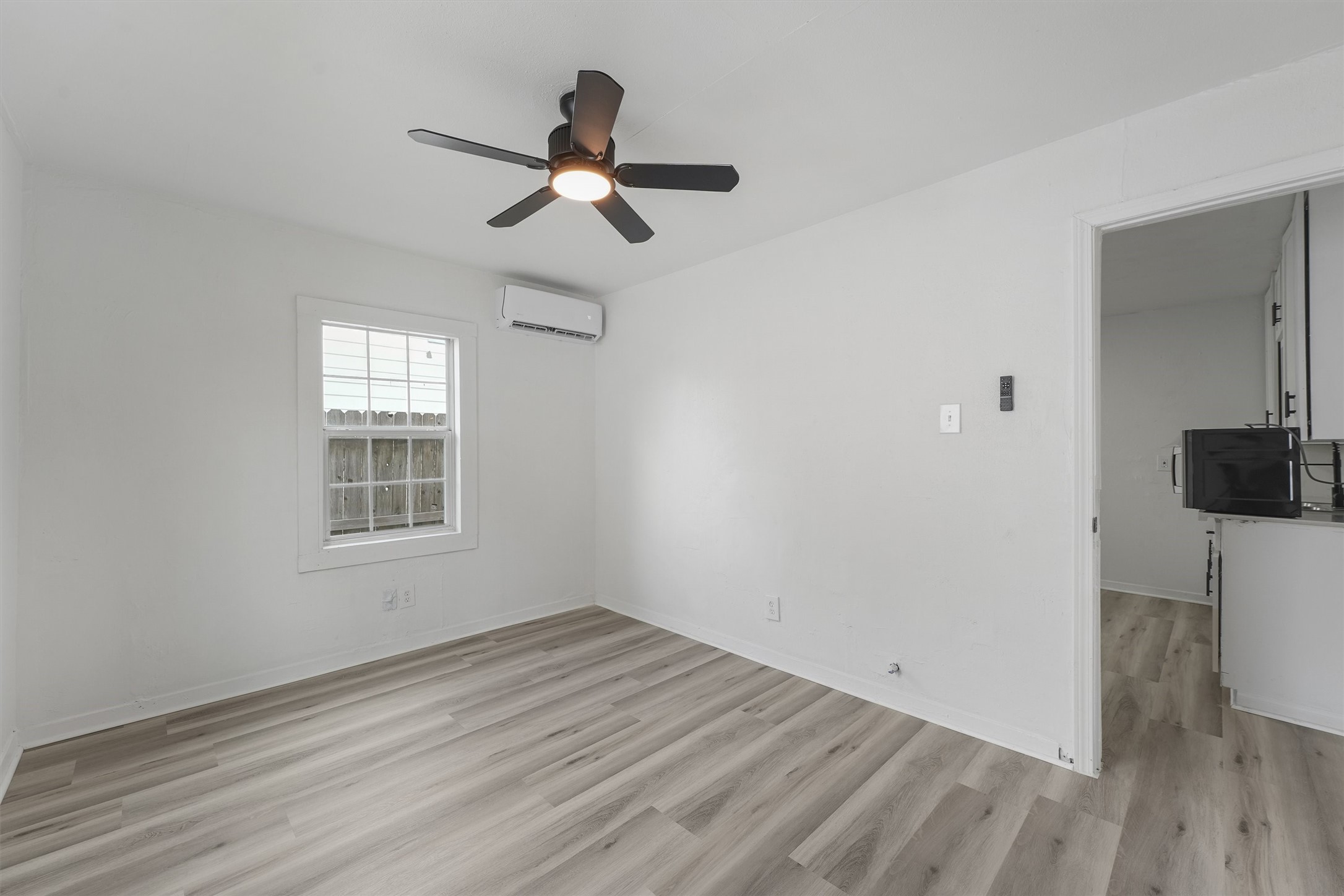 8514 Spaulding Street Houston, TX 77016 - Photo 6 of 19 a view of empty room with wooden floor and fan