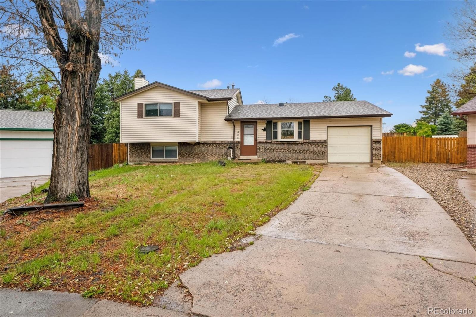 404 Neptune Court Lone Tree, CO 80124 - Photo 1 of 16 a view of a house with a yard