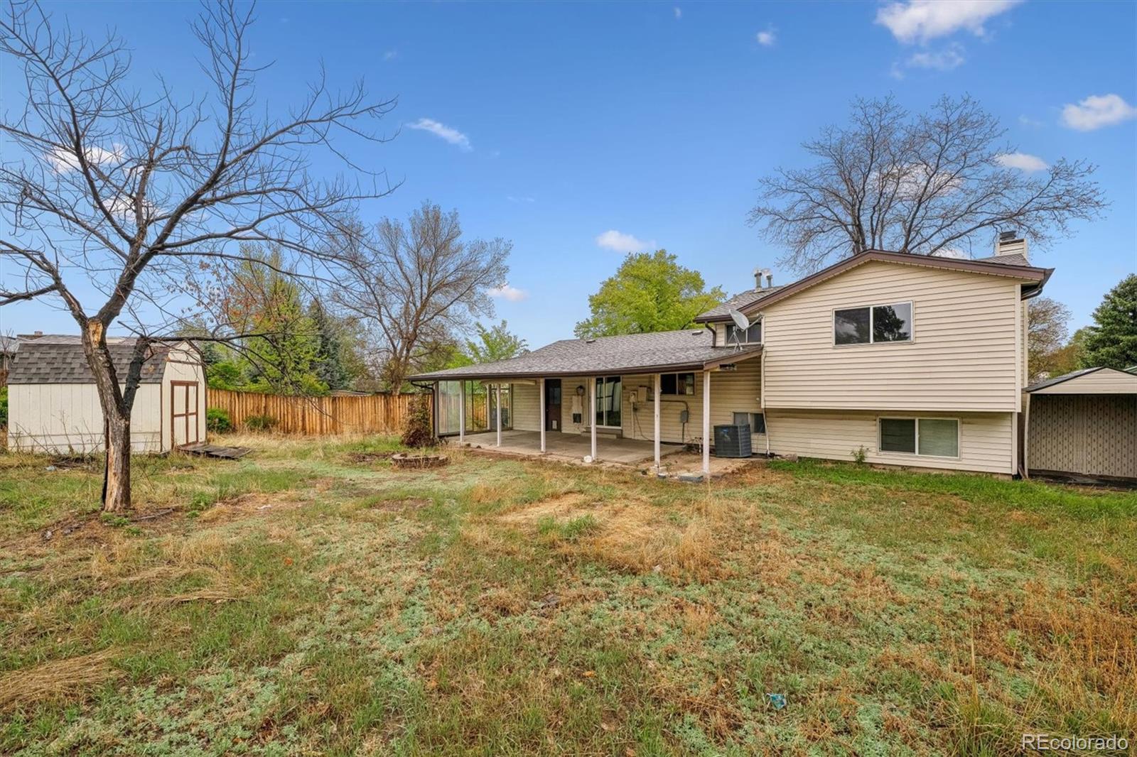 404 Neptune Court Lone Tree, CO 80124 - Photo 16 of 16 a view of a yard in front of a house with large trees