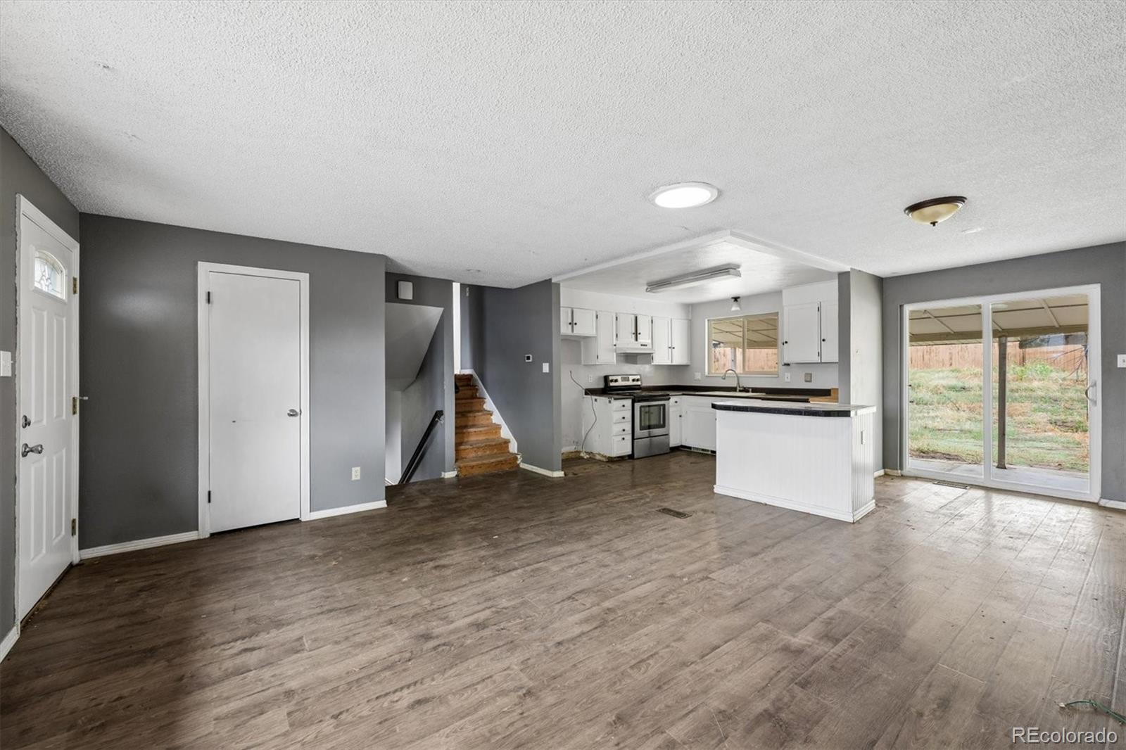 404 Neptune Court Lone Tree, CO 80124 - Photo 3 of 16 a view of empty room with wooden floor and windows