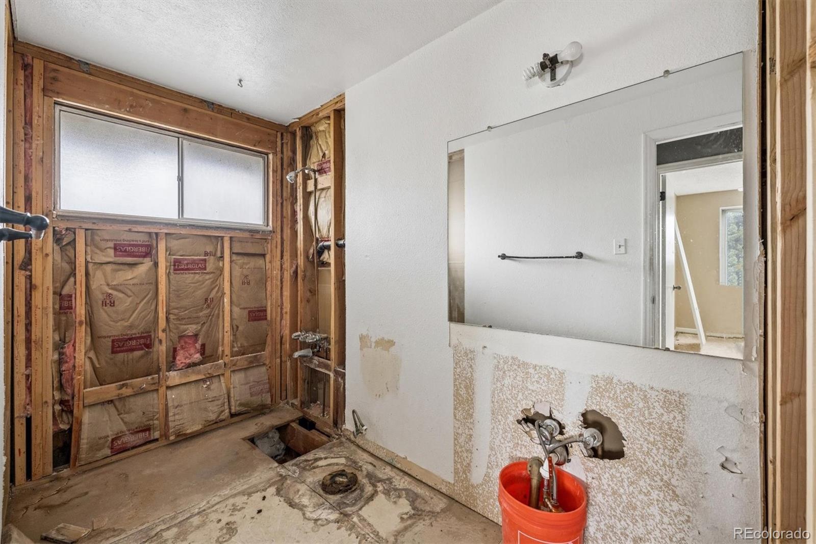 404 Neptune Court Lone Tree, CO 80124 - Photo 7 of 16 a bathroom with a tub and shower