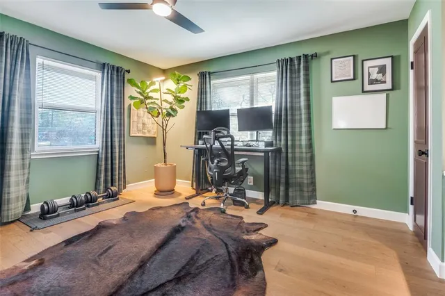 a bedroom with a bed and large windows