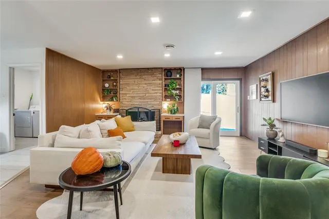 a living room with furniture and kitchen view