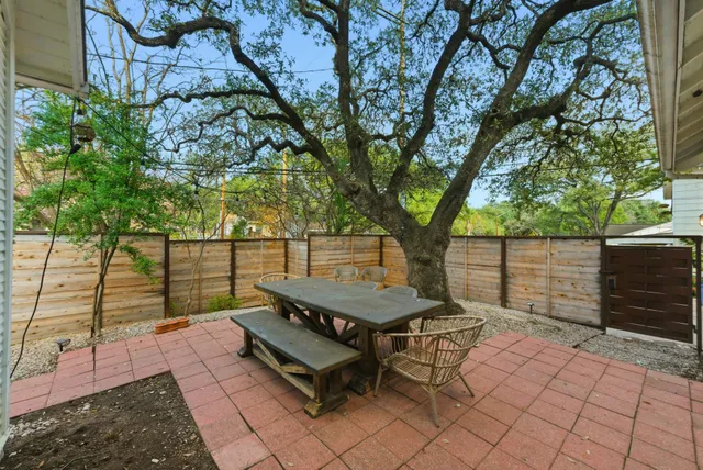 a park view with a bench and wooden fence