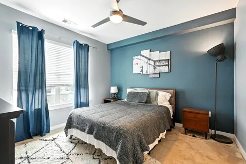 a bedroom with a bed and a chandelier