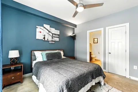 a bedroom with a bed and a chandelier