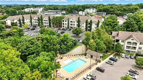 an aerial view of a house with a yard and lake view