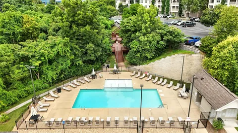 a view of a swimming pool with a patio and a garden