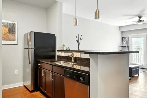 a kitchen with stainless steel appliances granite countertop a refrigerator and a sink