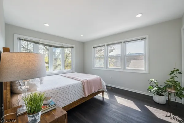 a bed sitting in a bedroom next to a window