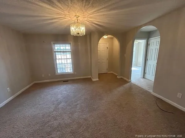an empty room that has a large window and painted walls