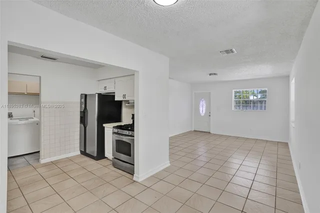 a view of kitchen with white cabinets