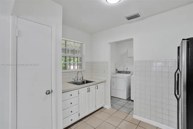 a spacious bathroom with a granite countertop sink a toilet and a shower