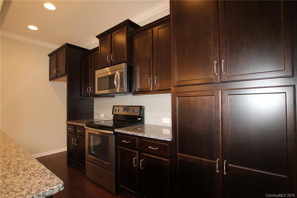 2254 Bluebell Way, Unit 156 Fort Mill, SC 29708 - Photo 6 of 23 a kitchen with stainless steel appliances granite countertop a refrigerator and a stove top oven
